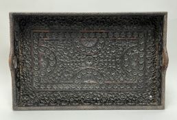 An early 20thc Anlgo-Indian hardwood twin-handled tray, intricately carved with floral and geometric