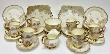 A Tuscan China tea service in the 'Plant' pattern, decorated with gilt handles and bases with