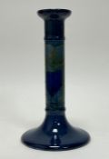 A William Moorcroft candlestick in the 'Moonlit' pattern, decorated with a hand-painted and