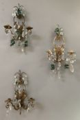 A set of three French wall sconces, patinated finish with twin branches wired for lights, with cut
