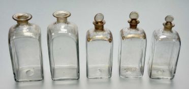 A collection of five graduated Dutch Gin bottles, with gilt feather the sun and stars to top,
