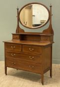 An Edwardian inlaid mahogany dressing chest, with bevelled oval mirror to top with two trinket