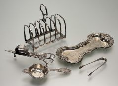 A modern Birmingham silver loose-leaf tea strainer with chased rococo style C and S scroll design: