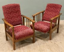 A pair of Edwardian oak-framed reclining armchairs, shaped arms and slat sides, with padded backs
