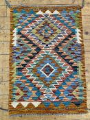 A hand-knotted Chobi kilim rug, central panel with two medallions on a multi-coloured ground and
