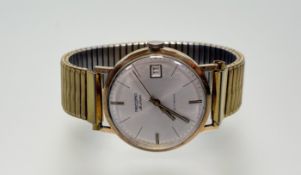 A vintage 9ct gold Record Deluxe presentation manual wind wristwatch with silvered dial baton hour