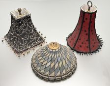 A collection of decorative lampshapes comprising, a red trumpet shaped shade with black lace