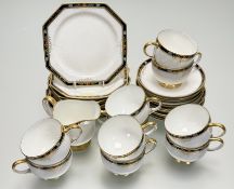 A Paragon part tea service in a flower head and gilt on cobalt blue rim pattern comprising, ten