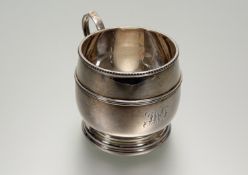 A Hamilton & Inches Edinburgh barrel style christening mug with beaded border and scroll ring handle