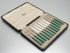 An Edwardian set of twelve pairs of epns bladed Sheffield silver mounted jade green plastic