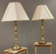 A pair of modern brass table lamps, candlestick style bases with cream shades: H. 58cm D. 18cm