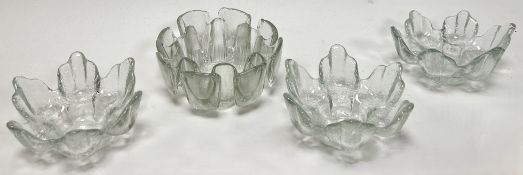 A collection of three Ravenhead frosted glass tea light candle holders in the form of lotus