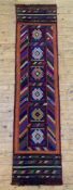 An unusual hand-knotted Suzni runner, central panel with six square medallions surrounded by bold