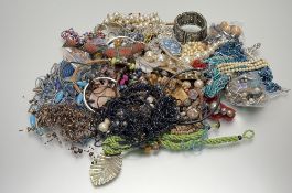 A very large collection of costume jewellery to include, bead necklaces, a white metal cuff-style