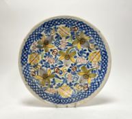 A late19thc/early 20thc Delft tin-glazed earthenware sharing plate, decorated with foliate motifs to