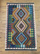 A hand-knotted Chobi kilim rug, central panel with three medallions on a multi-colour field and