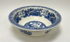 A large Wedwood blue and white wash basin in the 'Willow' pattern, decorated in the Chinese taste (