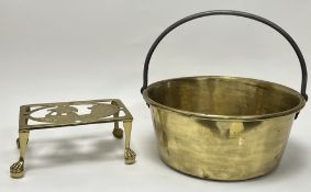 A brass jam pan with iron handle (h. 33cm), together with a brass trivet with pierced viking ship to