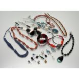 A collection of fashion costume jewellery to include bead necklaces, paste pearls, ceramic panel