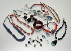 A collection of fashion costume jewellery to include bead necklaces, paste pearls, ceramic panel