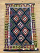 A hand-knotted Miamana kilim rug, central panel with repeating geometric motifs on a navy ground and