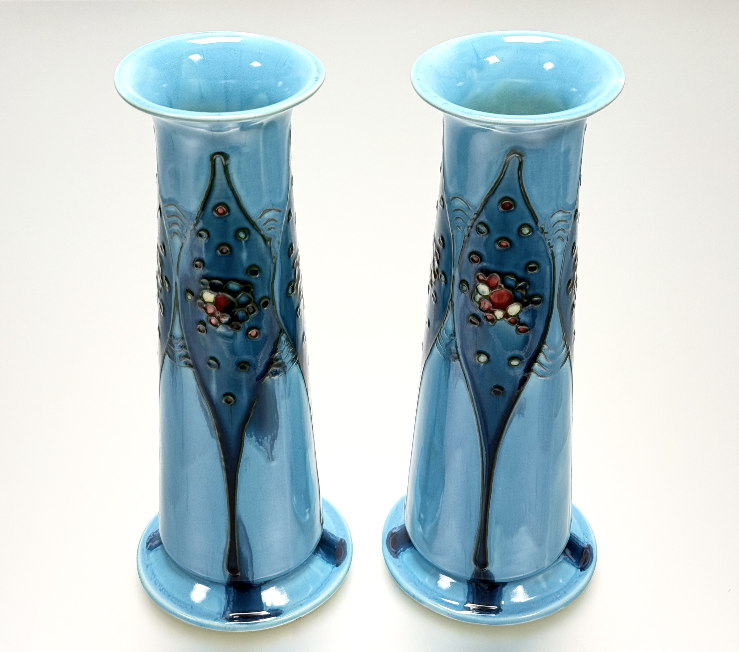 A pair of Minton "Secessionist" Ware vases, of tapering cylindrical form, tubelined and painted with
