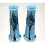 A pair of Minton "Secessionist" Ware vases, of tapering cylindrical form, tubelined and painted with