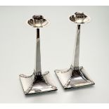 A pair of Edwardian silver candlesticks in the Arts & Crafts taste, James Dixon & Sons, Sheffield