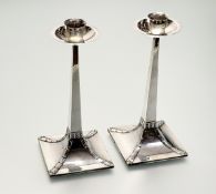 A pair of Edwardian silver candlesticks in the Arts & Crafts taste, James Dixon & Sons, Sheffield