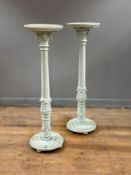 A pair of pine late 19thc torcheres/candlestands, with saucer tops, on acanthus leaf carved fluted