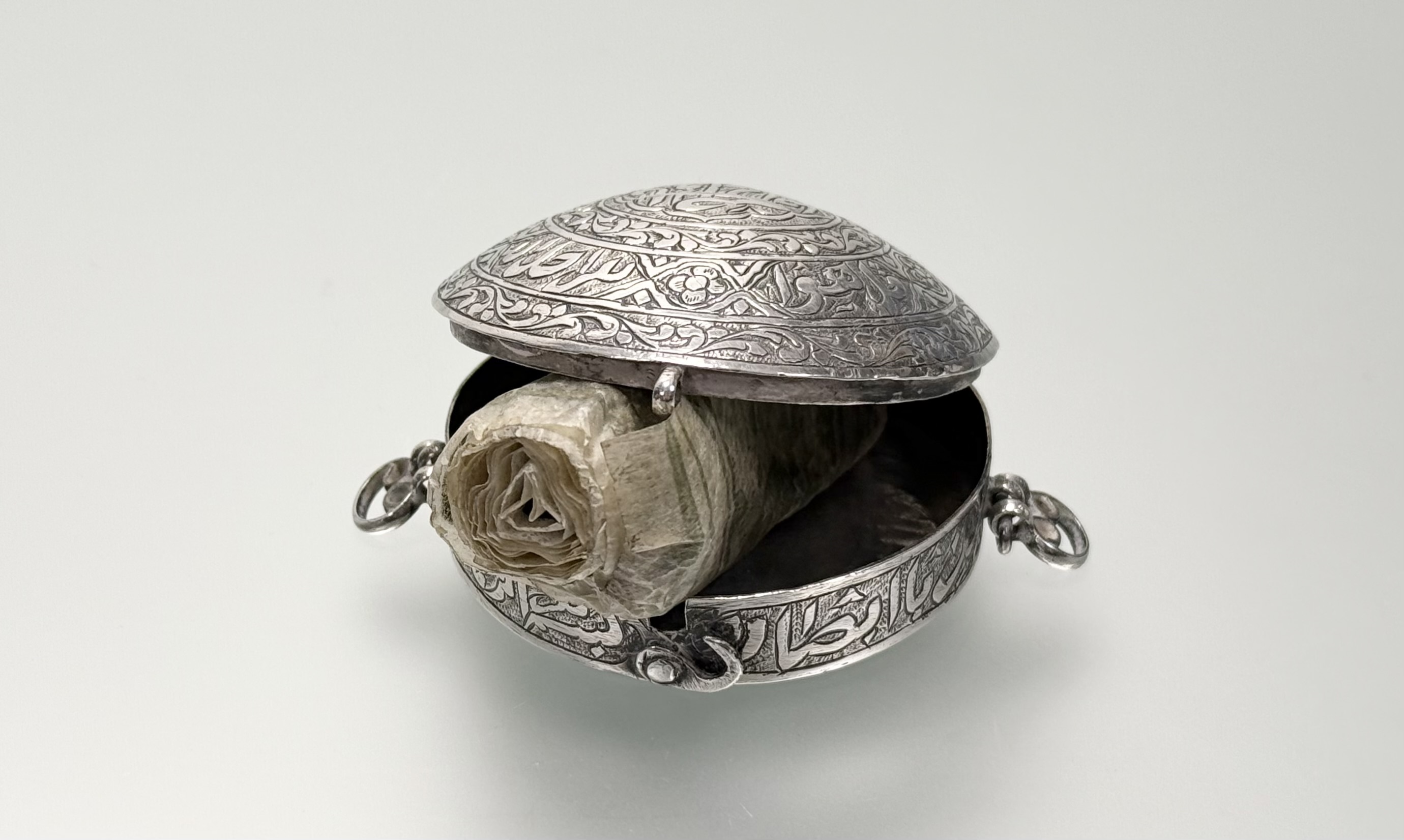 An Islamic (probably Persian) white metal Quran box, 19th century, circular with calligraphic - Image 5 of 5
