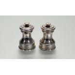 A pair of Edwardian silver pepperettes, Birmingham 1908 (maker's mark indistinct), of baluster form.