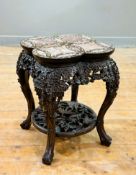 An unusual late 19thc Chinese cherrywood low stand, with quatrefoil top, with inlaid rouge marble