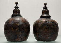 A pair of 19th century decoupage pottery urns, applied with figures and flowers, and with domed