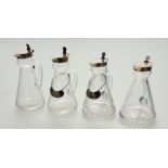 An assembled set of four silver-mounted cut-glass toddy jugs, two Hukin & Heath, Birmingham 1931,