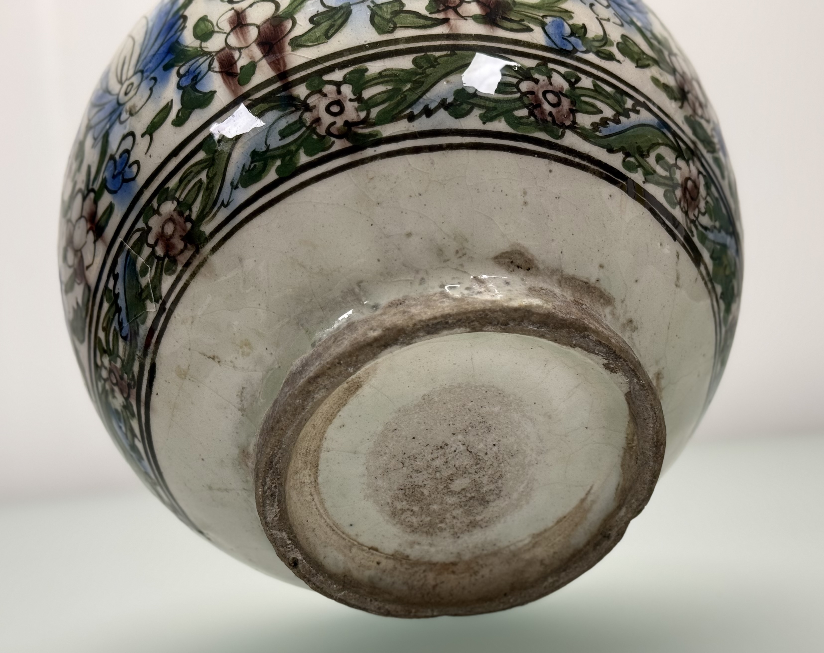 A Persian Qajar style pottery vase, probably early 20th century, painted with flowers and foliage. - Image 5 of 5