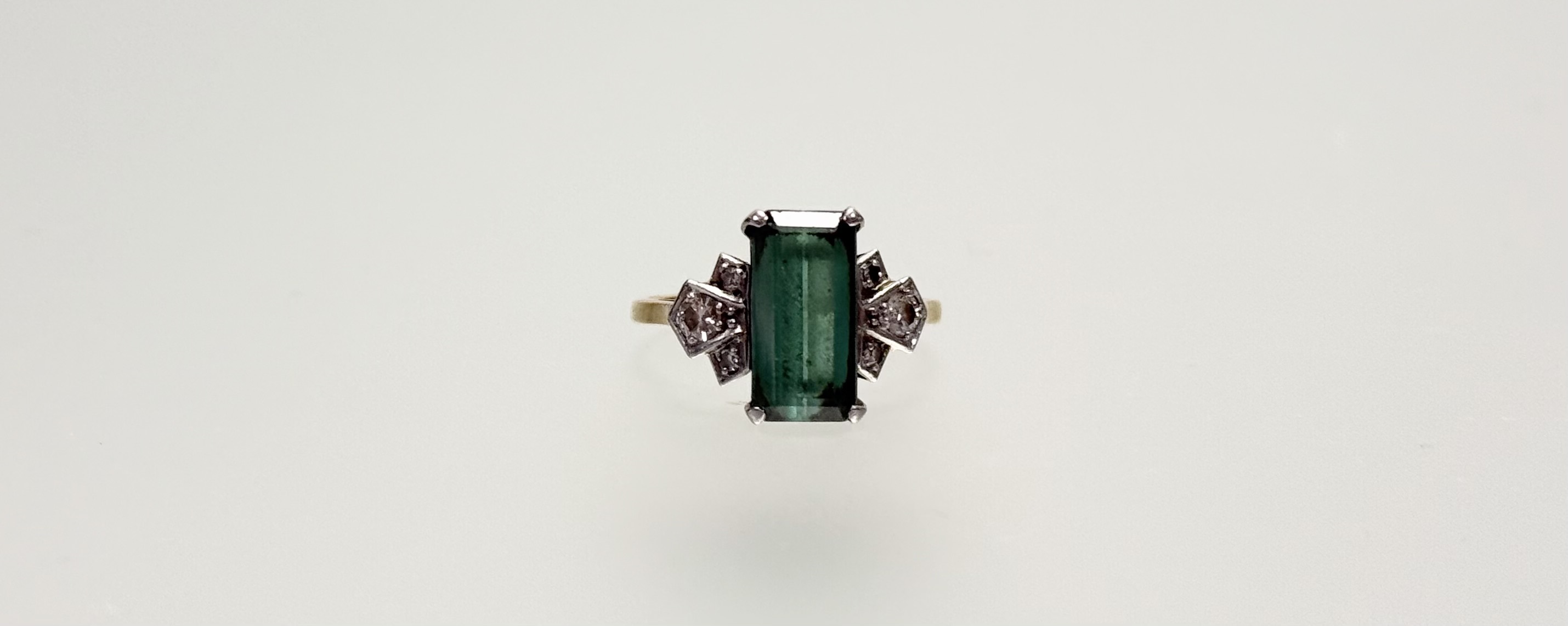A green tourmaline and diamond dress ring, the baguette-cut tourmaline claw-set between Deco- - Image 2 of 2