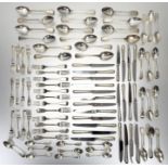 A George III style crossbanded walnut canteen table containing a composed silver flatware service,