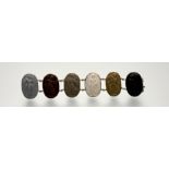 A 19th century lava cameo bracelet, formed of six oval cameos carved with Classical Muses, mounted