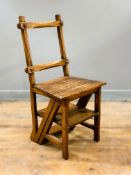A country made oak Gothic style metamorphic library chair, converting to a set of four steps, on