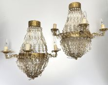 A pair of gilt-metal and prismatic cut-glass three-light wall lights, in 19th century style, each