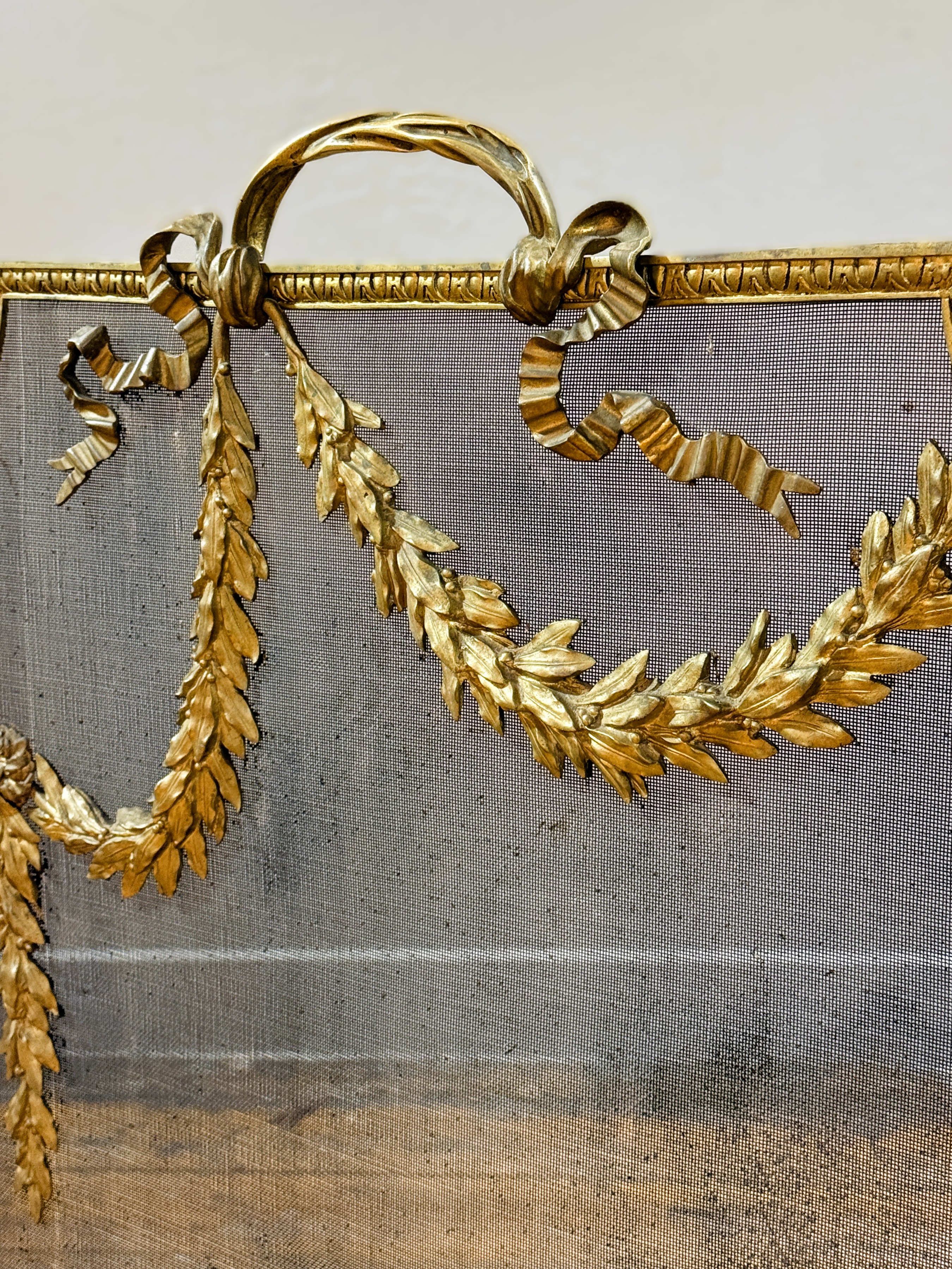 An Edwardian brass firescreen, the mesh screen applied with foliate and floral swags and raised on - Image 2 of 5