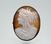 A late 19th century gold-mounted shell cameo brooch, the cameo carved with a profile bust of the