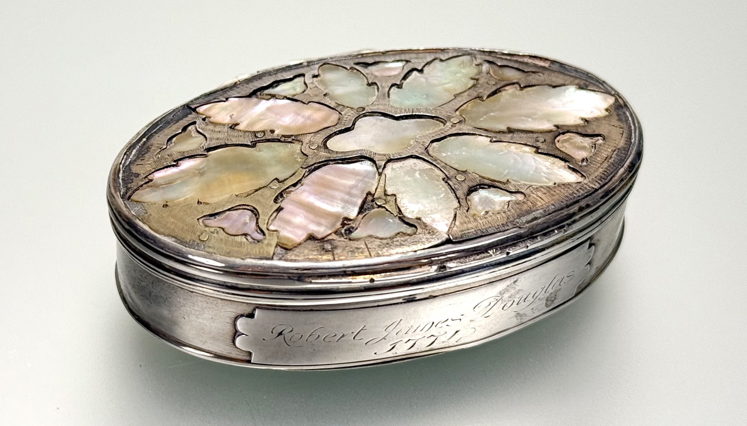 An 18th century mother-of-pearl inlaid silver (unmarked) snuff box, oval, the inside of the cover