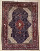 A fine hand-knotted Persian Tabriz carpet, central medallion surrounded by all-over floral motifs