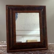 A William and Mary oyster-veneered walnut cushion-framed mirror,(with later plate and easel back),