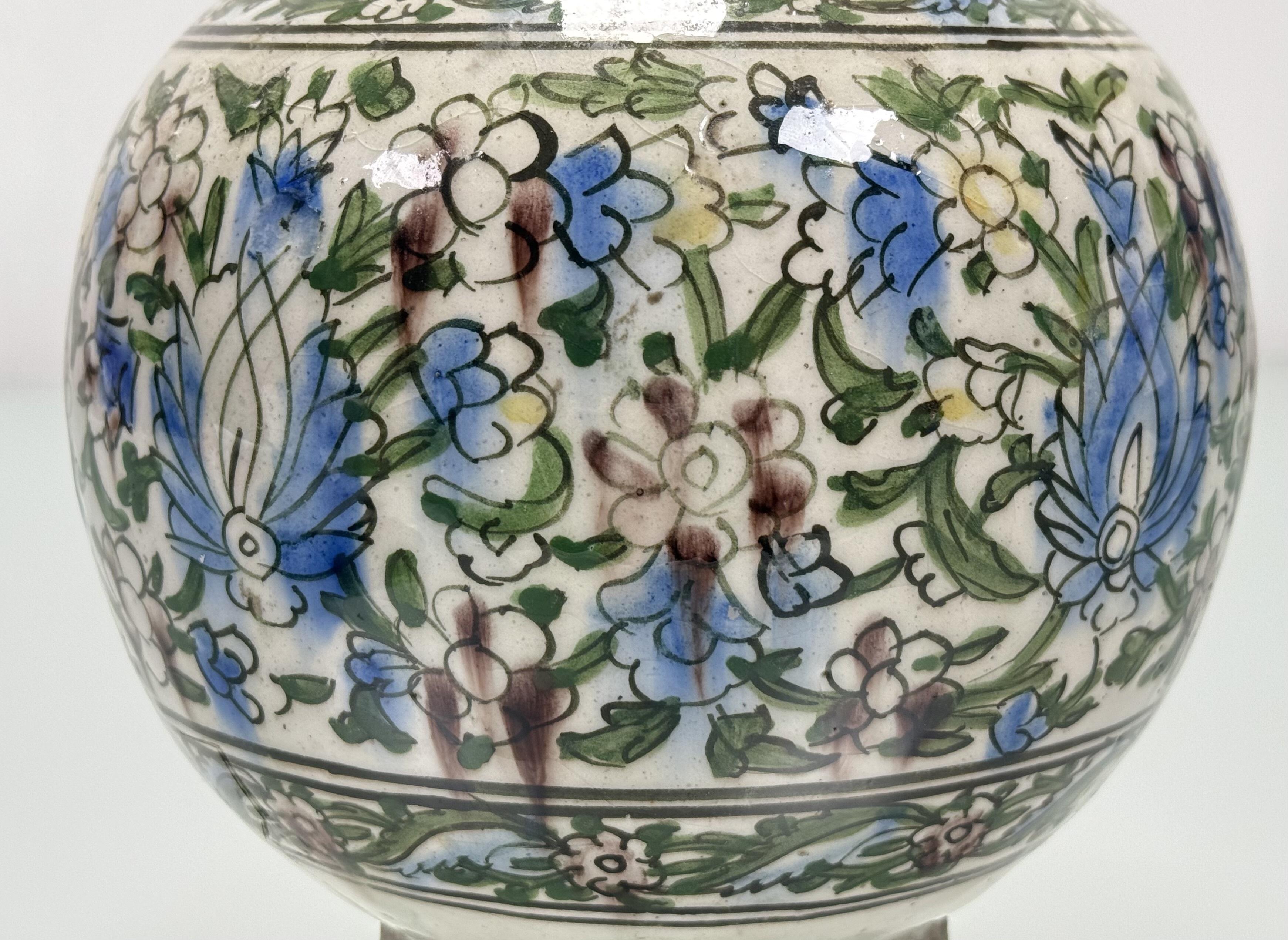 A Persian Qajar style pottery vase, probably early 20th century, painted with flowers and foliage. - Image 3 of 5