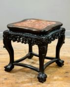 A Chinese late 19thc./early 20thc. cherrywood vase stand with scalloped top and inset marble panel