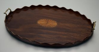 A large Edwardian inlaid mahogany twin-handled tray, in 18th century style, oval, centred by an
