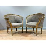 A pair of late 19thc French bergeres with giltwood carved foliate backs, with scroll arms, on fluted